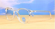 Large round clear blue blocker glasses with silver stud detail and flexible steel hinges