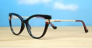 Vintage cat-eye blue blocker glasses in black with purple and gold highlights and gold metal temples