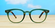 Vintage-style translucent green computer glasses with tortoise temples and wire-core temples
