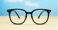 Round shiny black TR90 anti blue light glasses with gold detailing and steel hinges