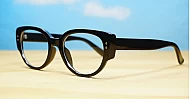 Chunky oval blue blocker glasses with robust steel hinges