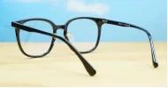 Round shiny black TR90 anti blue light glasses with gold detailing and steel hinges