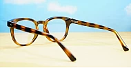 Round medium blue blocker glasses in black or tortoise with inner core wire temples