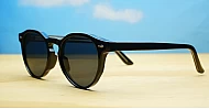 The Acorn small unisex vintage round UV400 sunglasses in shiny black with silver accents and dark lenses