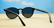 The Acorn small unisex vintage round UV400 sunglasses in shiny black with silver accents and dark lenses