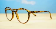 Round tortoise anti blue light glasses with gold accents and steel hinges