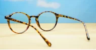 Round tortoise anti blue light glasses with gold accents and steel hinges