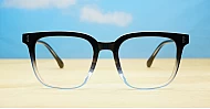 Square black to clear fade blue blocker glasses with silver details and pins