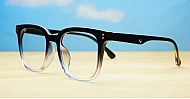 Square black to clear fade blue blocker glasses with silver details and pins