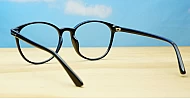 Black computer glasses with gold accents and blue light lenses