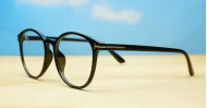 Black computer glasses with gold accents and blue light lenses
