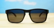 Tama Black curved wrap polarised sunglasses silver detail dark grey lenses