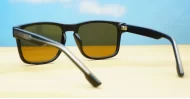 The Comet sporty black UV400 sunglasses for men with Oakley-inspired wrap frames and brown Category 3 lenses