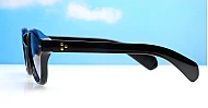 The Gigi round vintage UV400 sunglasses in black with gold arrow detailing and gradient dark grey lenses