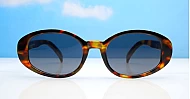 The Freya medium retro oval UV400 sunglasses in translucent or solid colours with super dark lenses