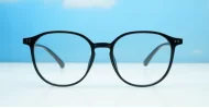 Round shiny black TR90 blue blocker glasses with silver pin temple detailing