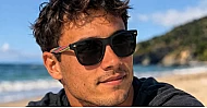 Skate unisex polarised sunglasses with matte black frames and bamboo arms with multi-coloured stripes