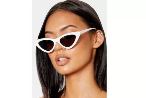 lady wearing cateye sunglasses in nz. White frames