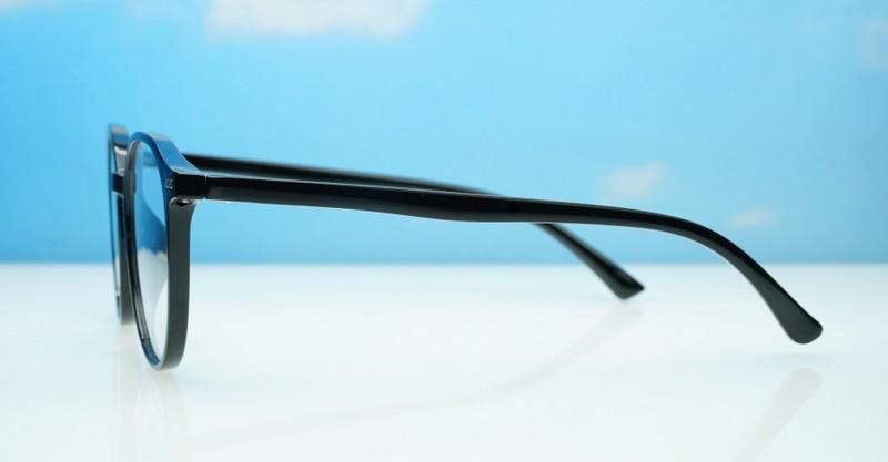 Round shiny black TR90 blue blocker glasses with silver pin temple detailing