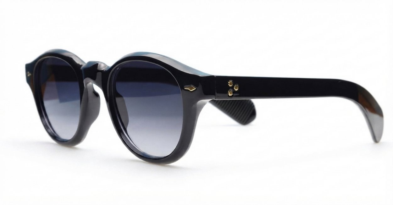 The Gigi round vintage UV400 sunglasses in black with gold arrow detailing and gradient dark grey lenses