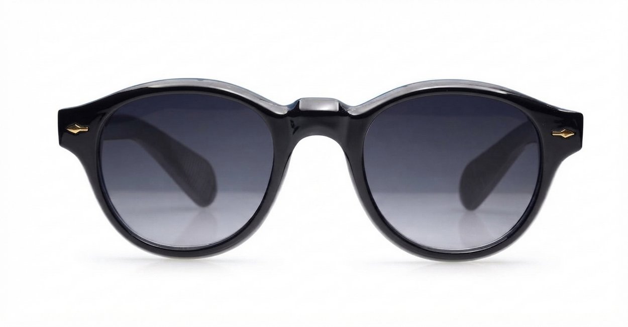The Gigi round vintage UV400 sunglasses in black with gold arrow detailing and gradient dark grey lenses